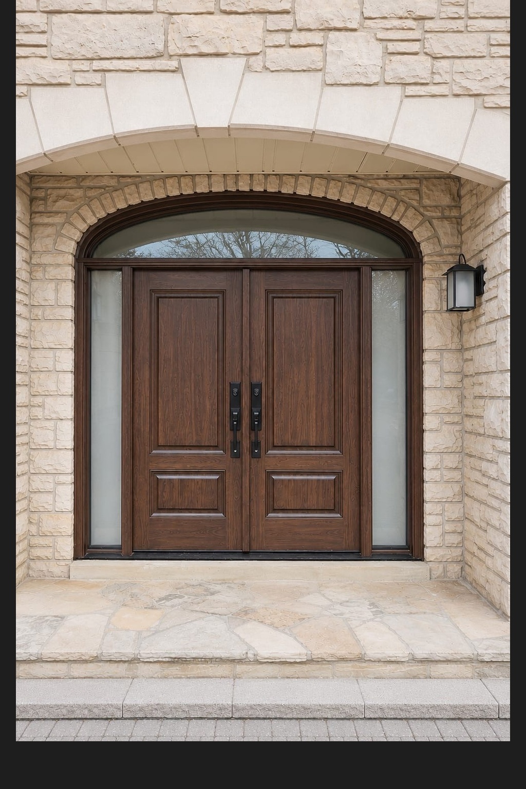 Stone home entry after installation of a stained wood double entry door with sidelites and arched transom